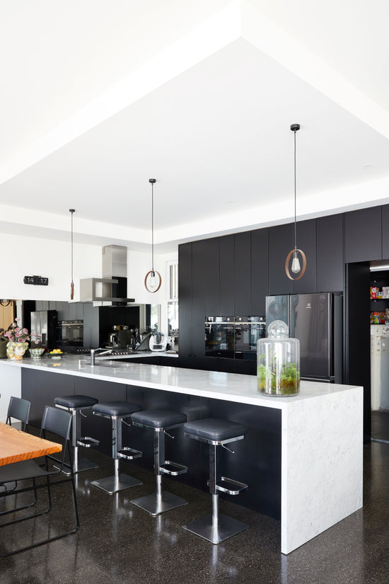 Original Newtown kitchen prior to renovation by Nikki McGar Interiors, showing outdated cabinetry and neutral finishes and mirrored splashback 