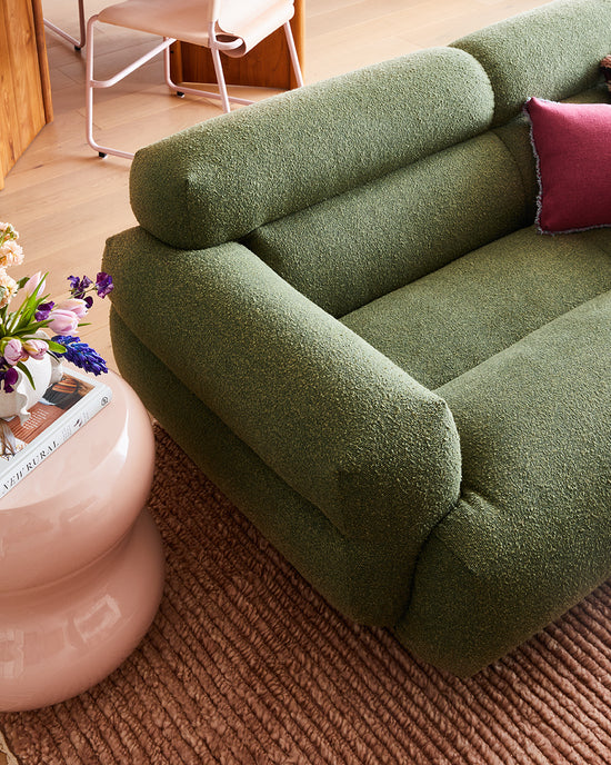 Close-up of a Green Valley sofa by Jardan with a pastel pink chubby side table from fenton and fenton in a St Leonards living room designed by Nikki McGar Interiors.