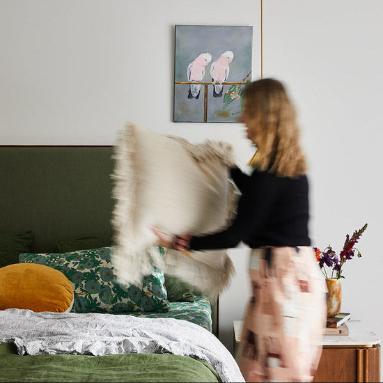 Bedroom design in Wallington by Nikki McGar Interiors with a custom bedhead and soft layered linens.