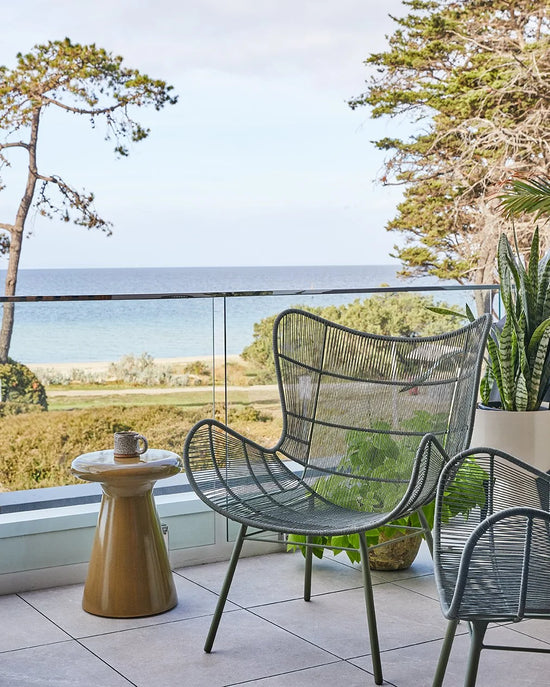Modern balcony design in St Leonards featuring GlobeWest outdoor seating and neutral textured styling by Nikki McGar Interiors.