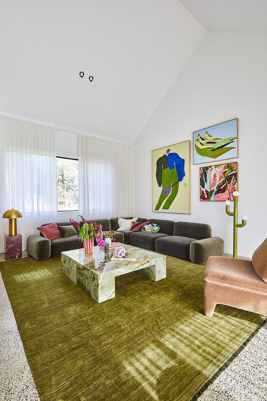 After: Wallington living room designed by Nikki McGar Interiors featuring large-scale statement artwork, bold colour, and a neutral backdrop for balance and warmth.