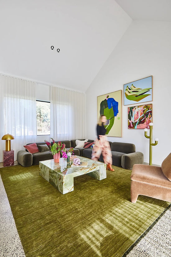 Living room design in Wallington showcasing large-scale art and vibrant colour against a calm, neutral base by Nikki McGar Interiors.